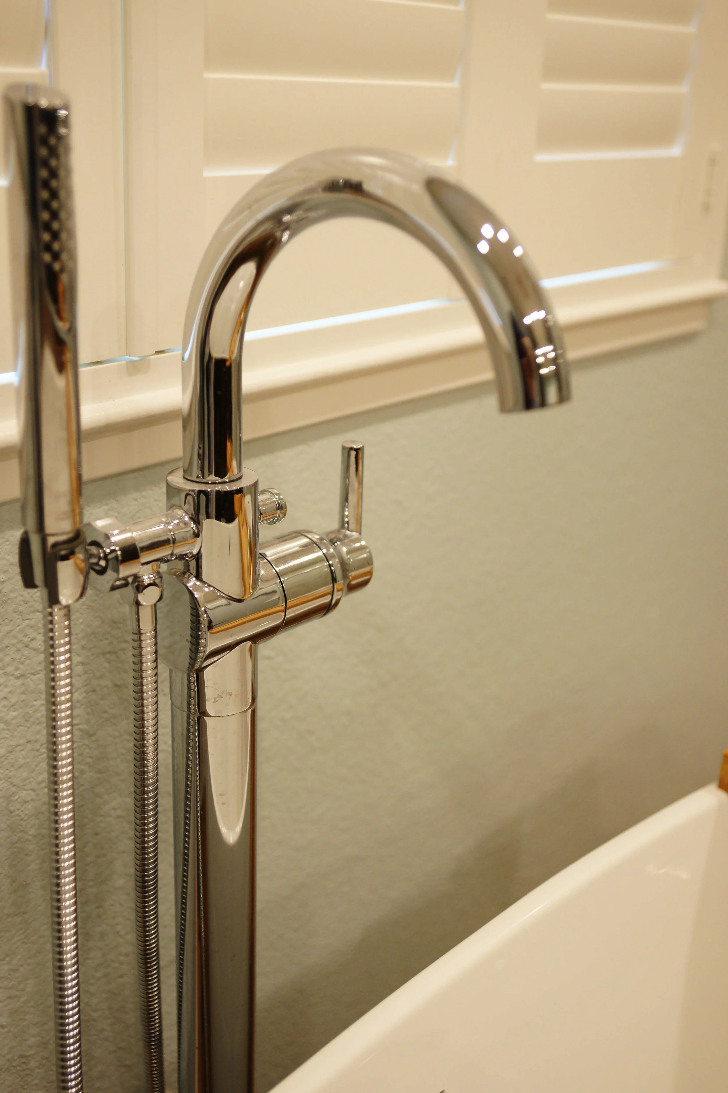 Design detail: Freestanding tub faucet with hand shower.