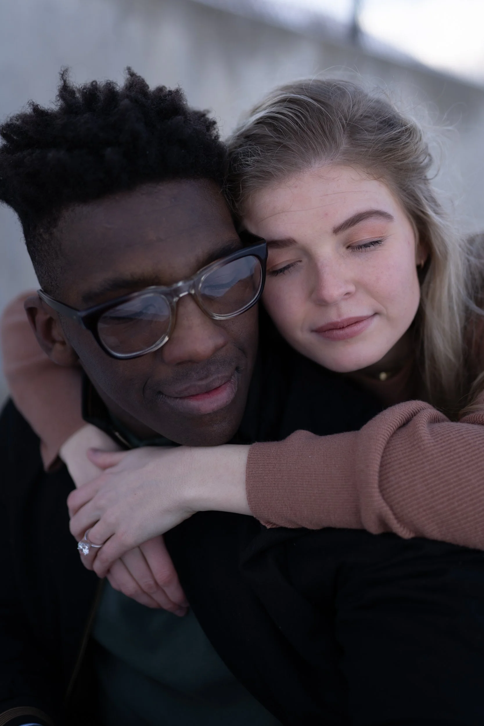 Photo of man and woman embraced in a hug with their eyes closed edited with Archipelago Lightroom Presets
