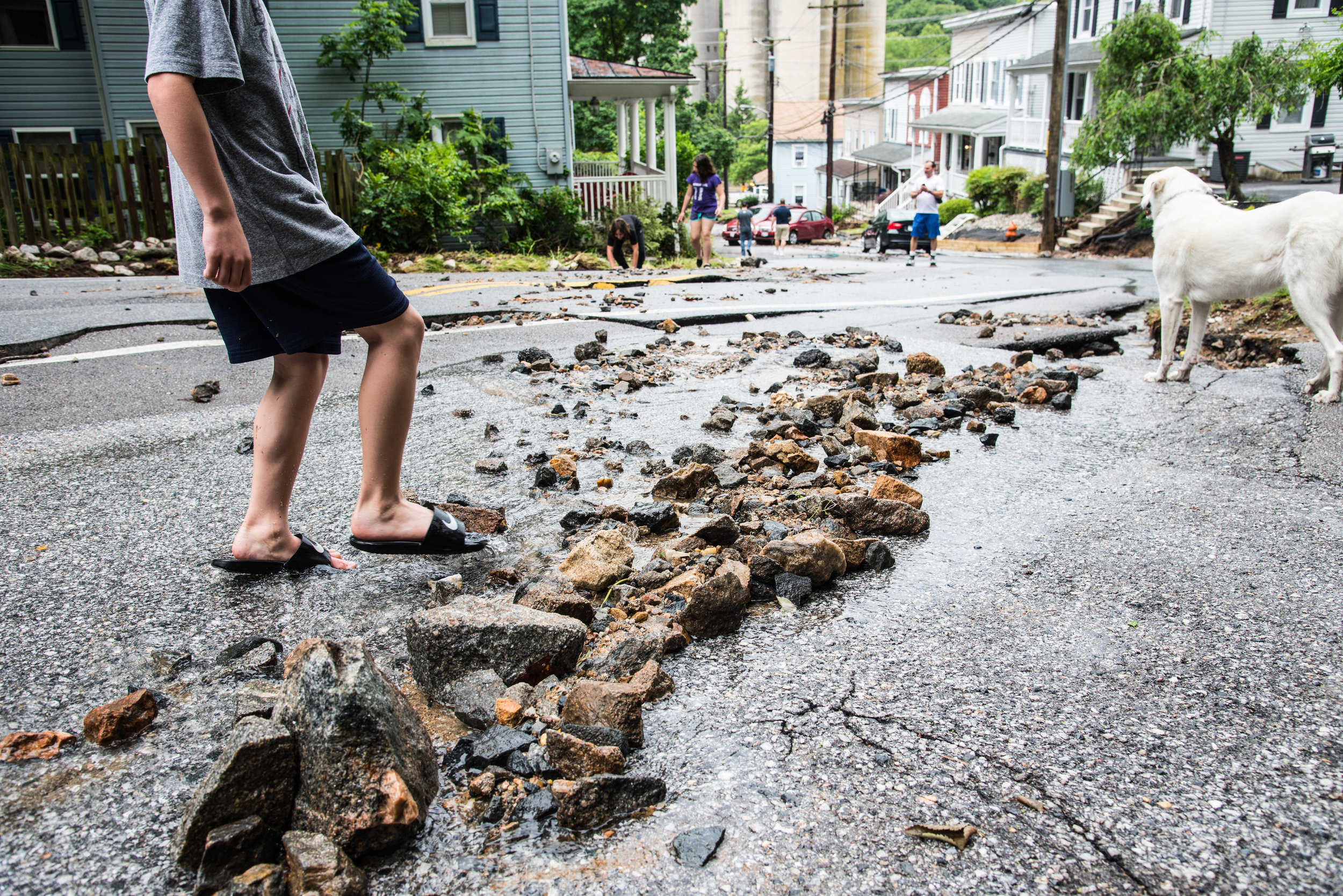 The day after the 2018 flood swept through, local residents walked the streets to survey the damage.