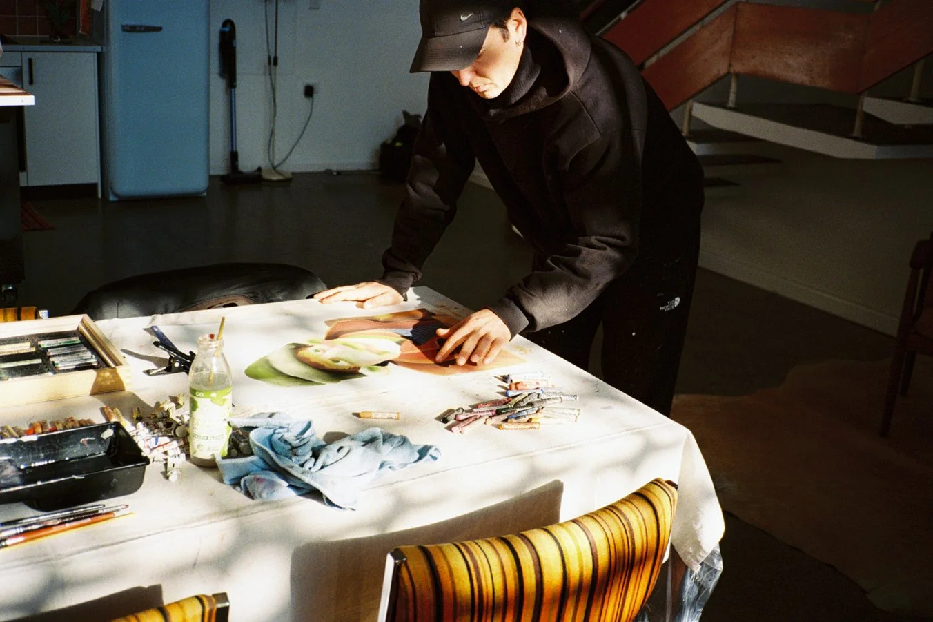 rhys viorr painting portraits on paper at the artist residency near sydney in port kembla