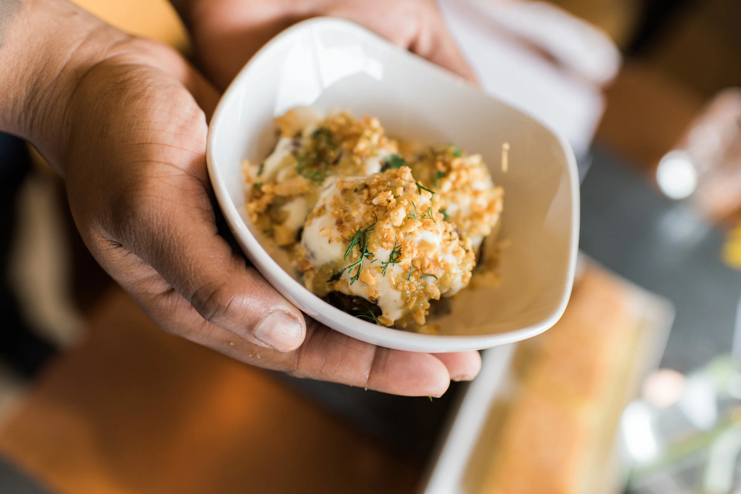 Crispy cauliflower, citrus yogurt, pickled raisin puree, spiced peanuts, and dill.