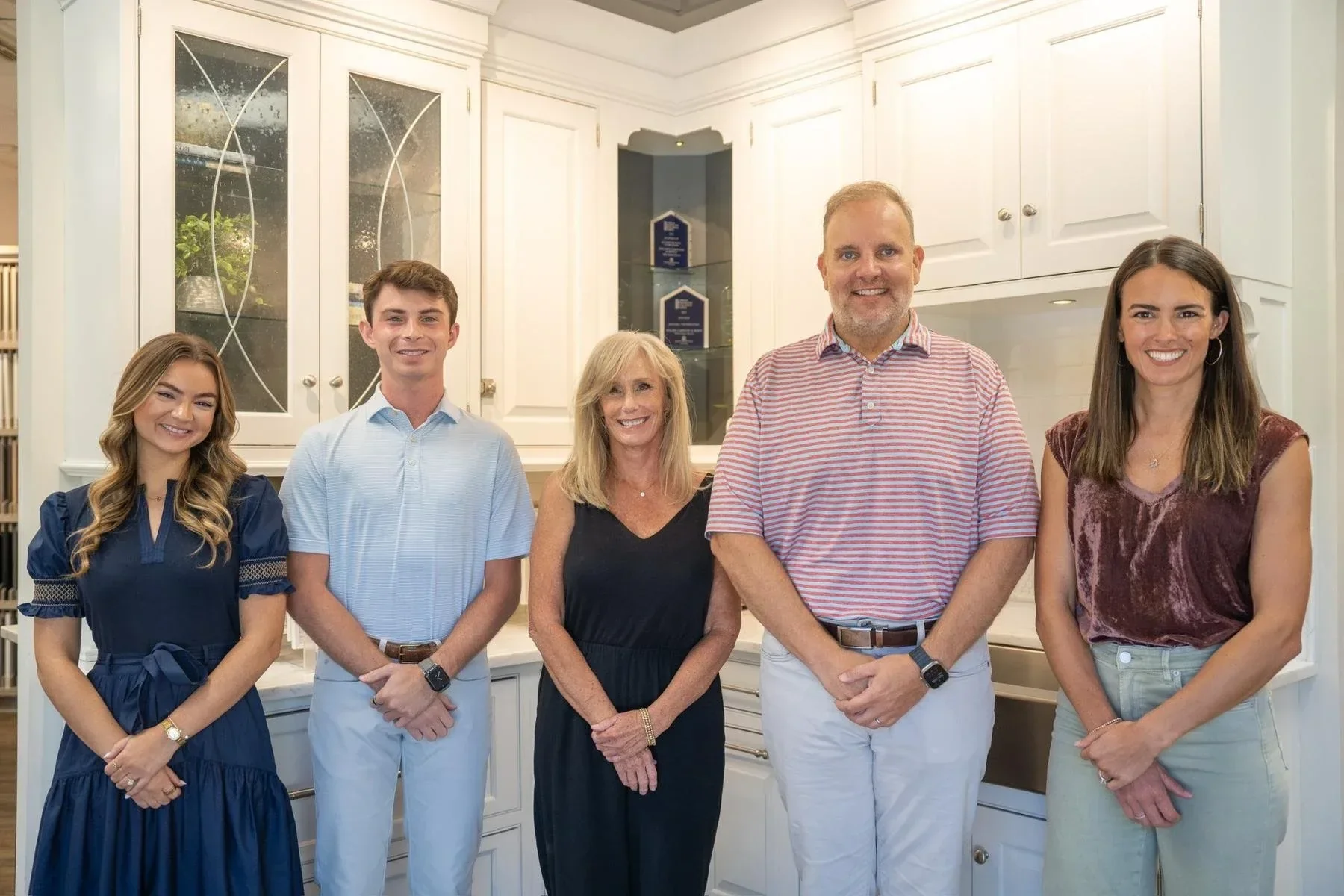 Toulmin Kitchen & Bath design team in the Tuscaloosa studio surrounded by custom kitchen cabinetry.