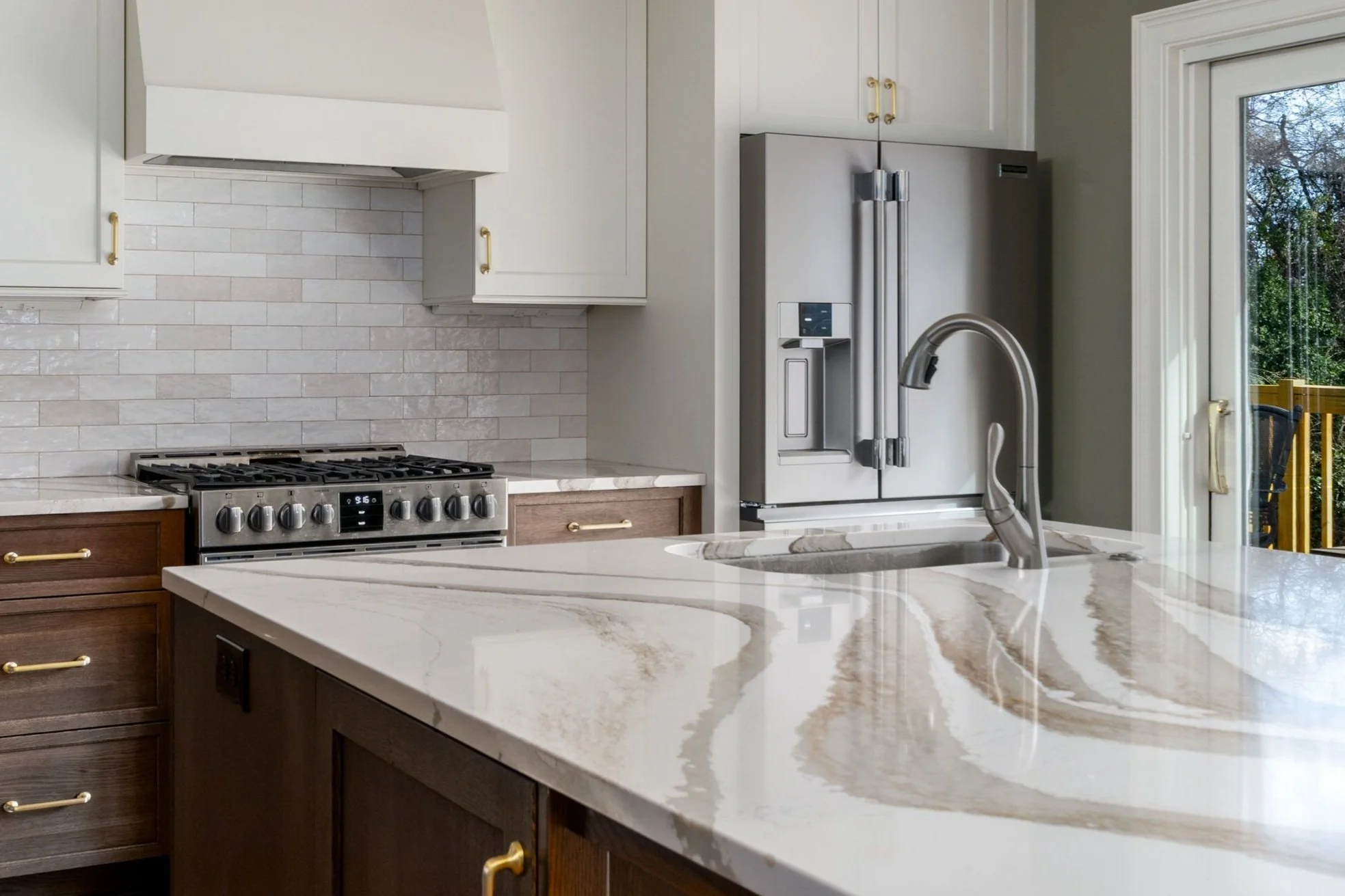 Kitchen remodel with custom cabinetry, large island, accessible sink, French-door refrigerator, range, and easy-to-reach storage.