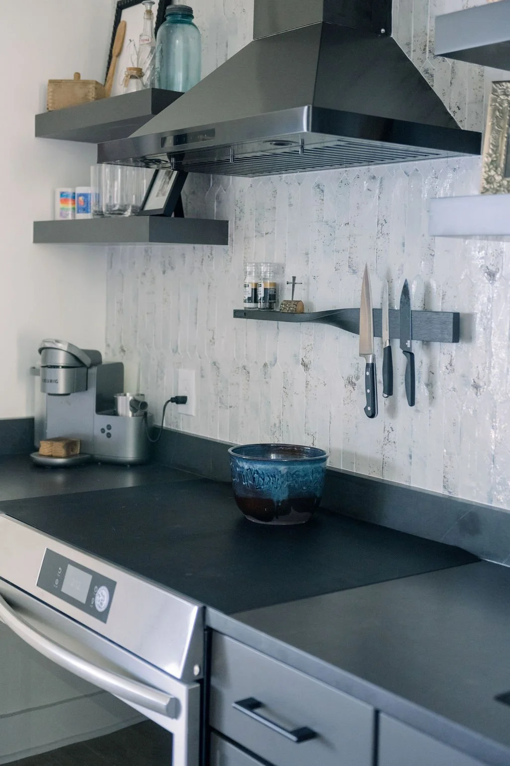 Basement Kitchen with Black Quartz Countertops, Textured Backsplash, and Open Shelving – Toulmin Kitchen & Bath