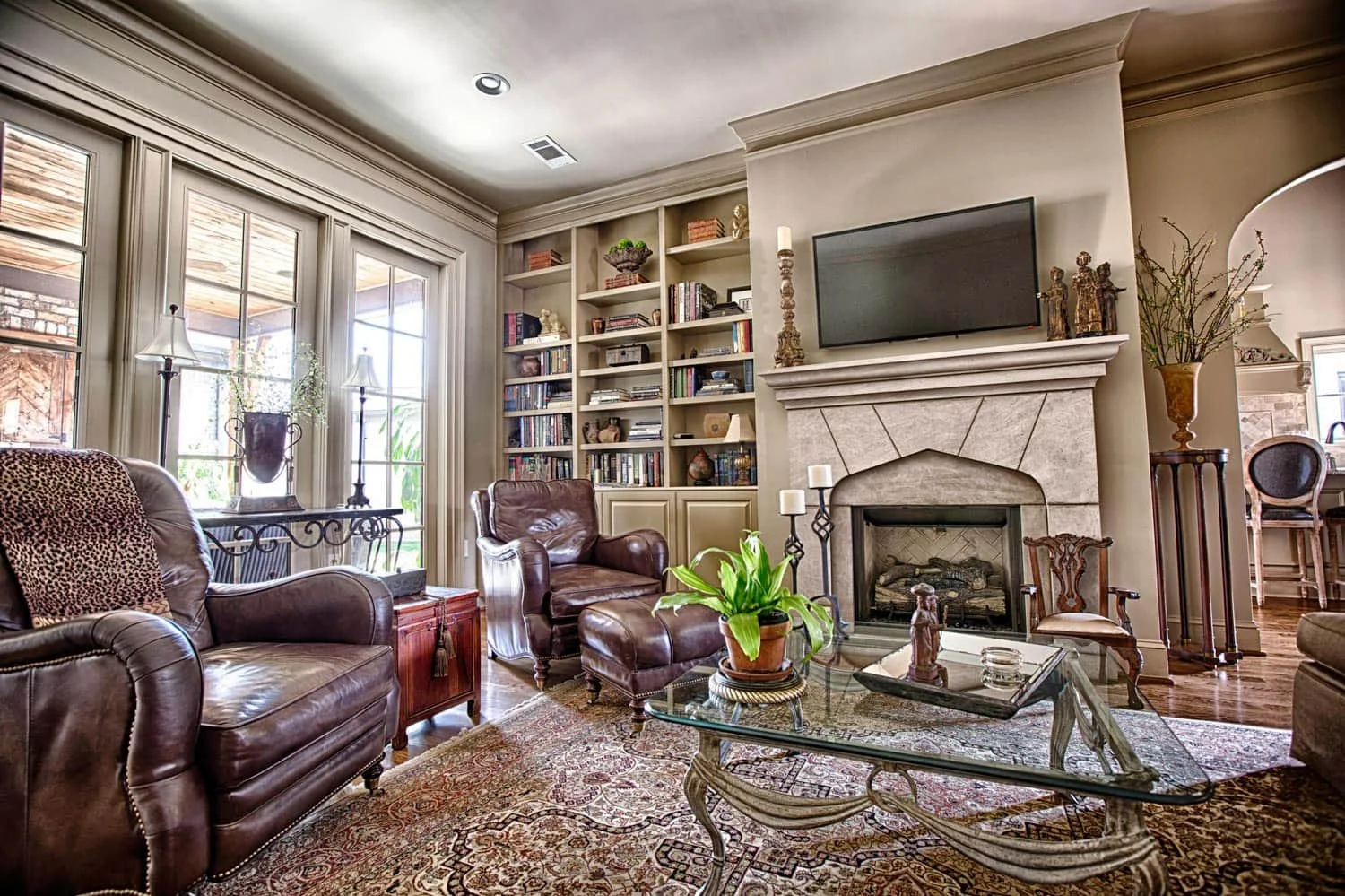 Comfortable and energy-efficient Alabama living room featuring built-in cabinetry, custom shelving, and a fireplace during a home remodeling project.