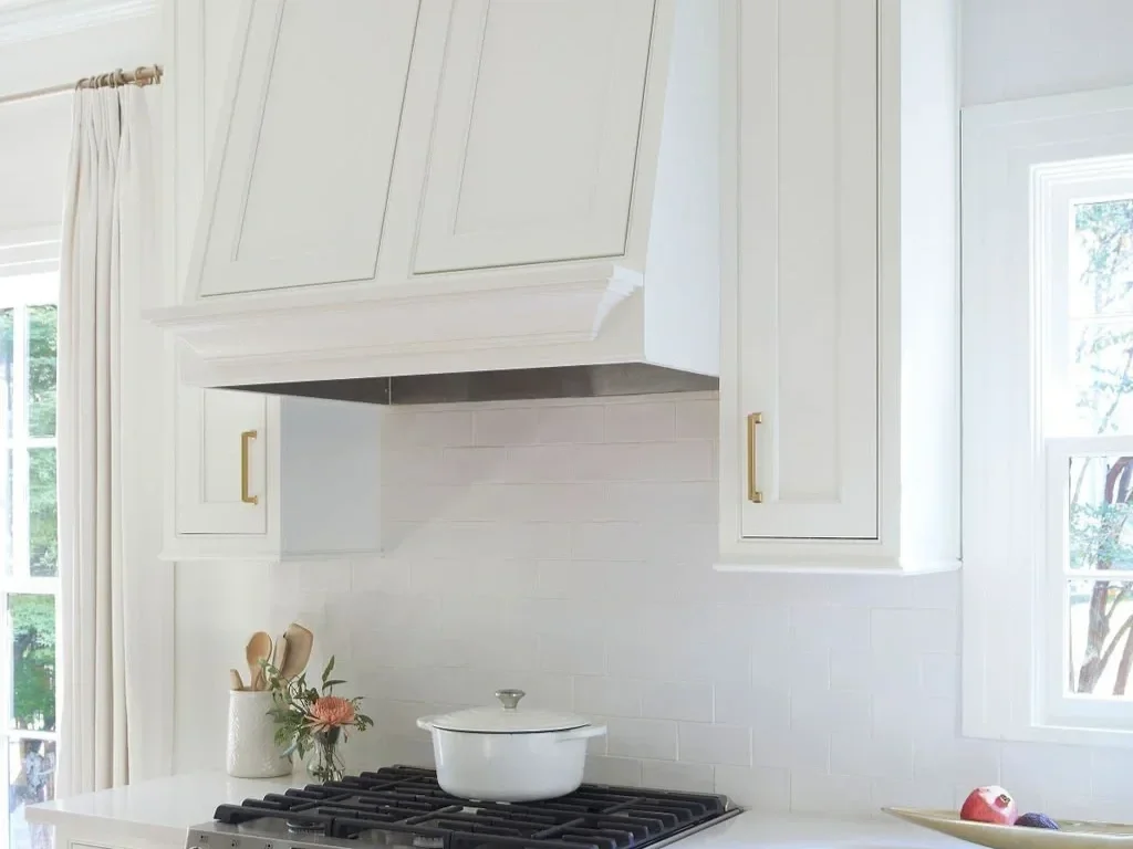 White kitchen with custom white cabinetry and Adex handmade matte crackled subway tile backsplash, creating a clean, textured, and timeless design