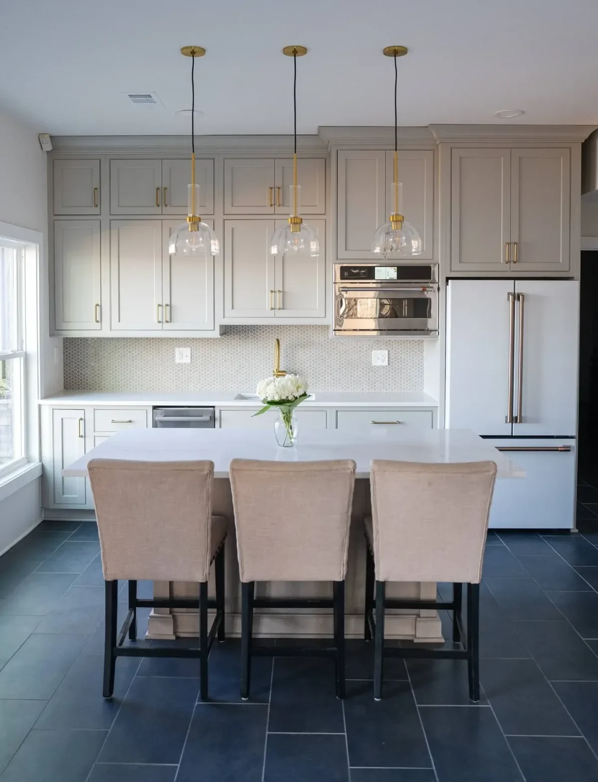 Gray custom kitchen cabinetry with quartz countertops and pendant lighting in a Northport, Alabama kitchen remodel.