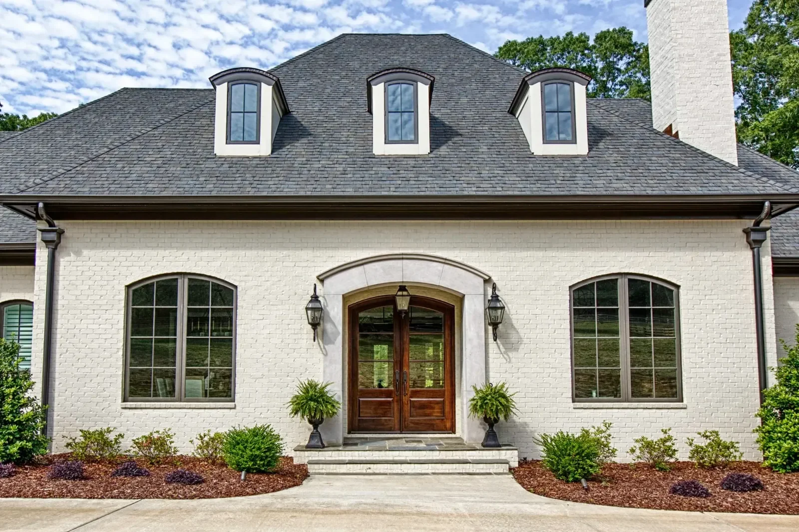Traditional Alabama home featuring custom wood entry doors and large Sierra Pacific windows that enhance curb appeal and natural light.