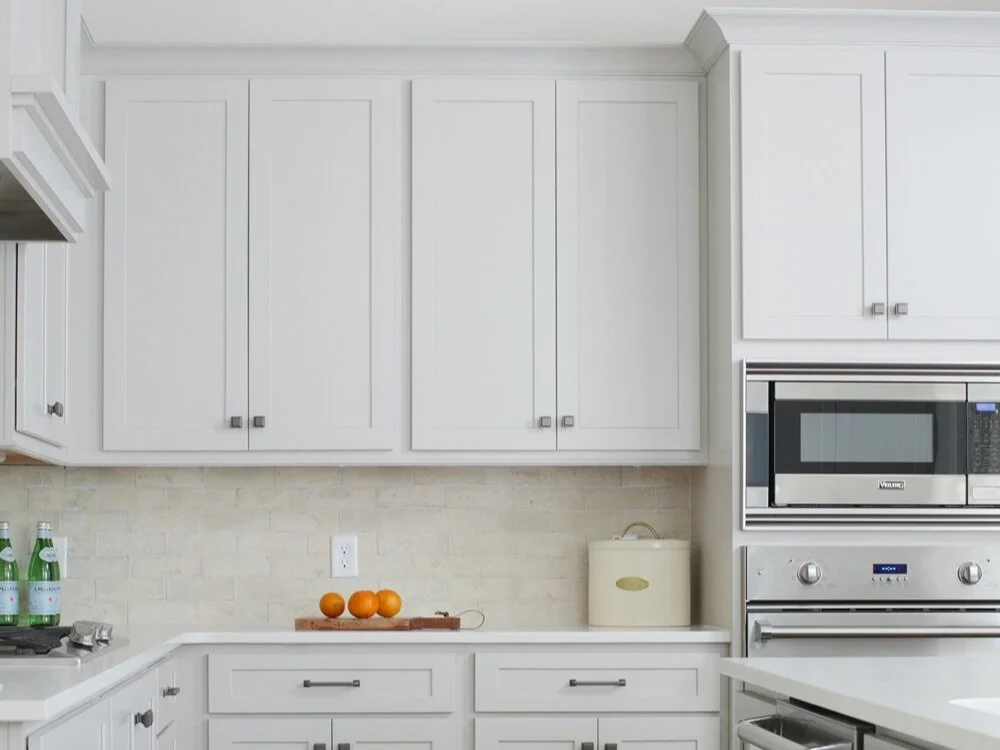Kitchen with Agreeable Gray Cabinetry and Medium Stained Wood Floors.jpg