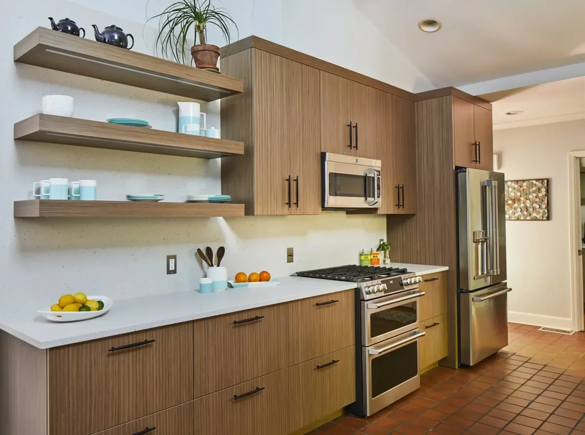 Mid-century modern kitchen with walnut veneer cabinetry, floating shelves, and quartz countertops.