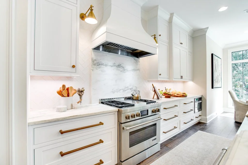 White beaded inset Shiloh custom cabinetry paired with Adex “Earth” collection tile backsplash, creating a clean, refined kitchen with subtle texture and a modern aesthetic