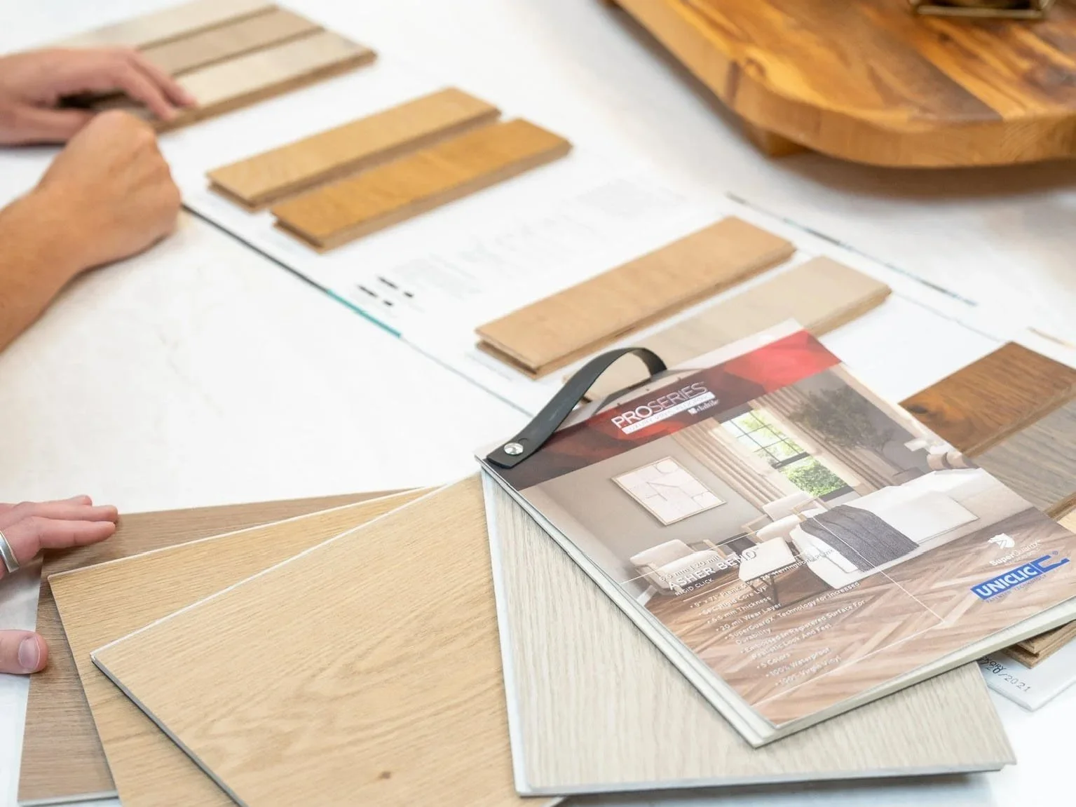 Wood flooring samples being compared for a kitchen remodel at Toulmin Kitchen & Bath in Tuscaloosa, Alabama