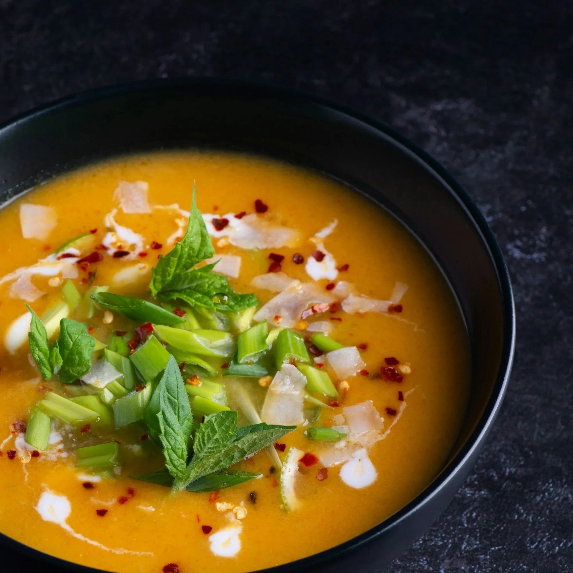 Bowl of soup with a spoon, simple and comforting meal ideal for easy cooking during a kitchen remodel.