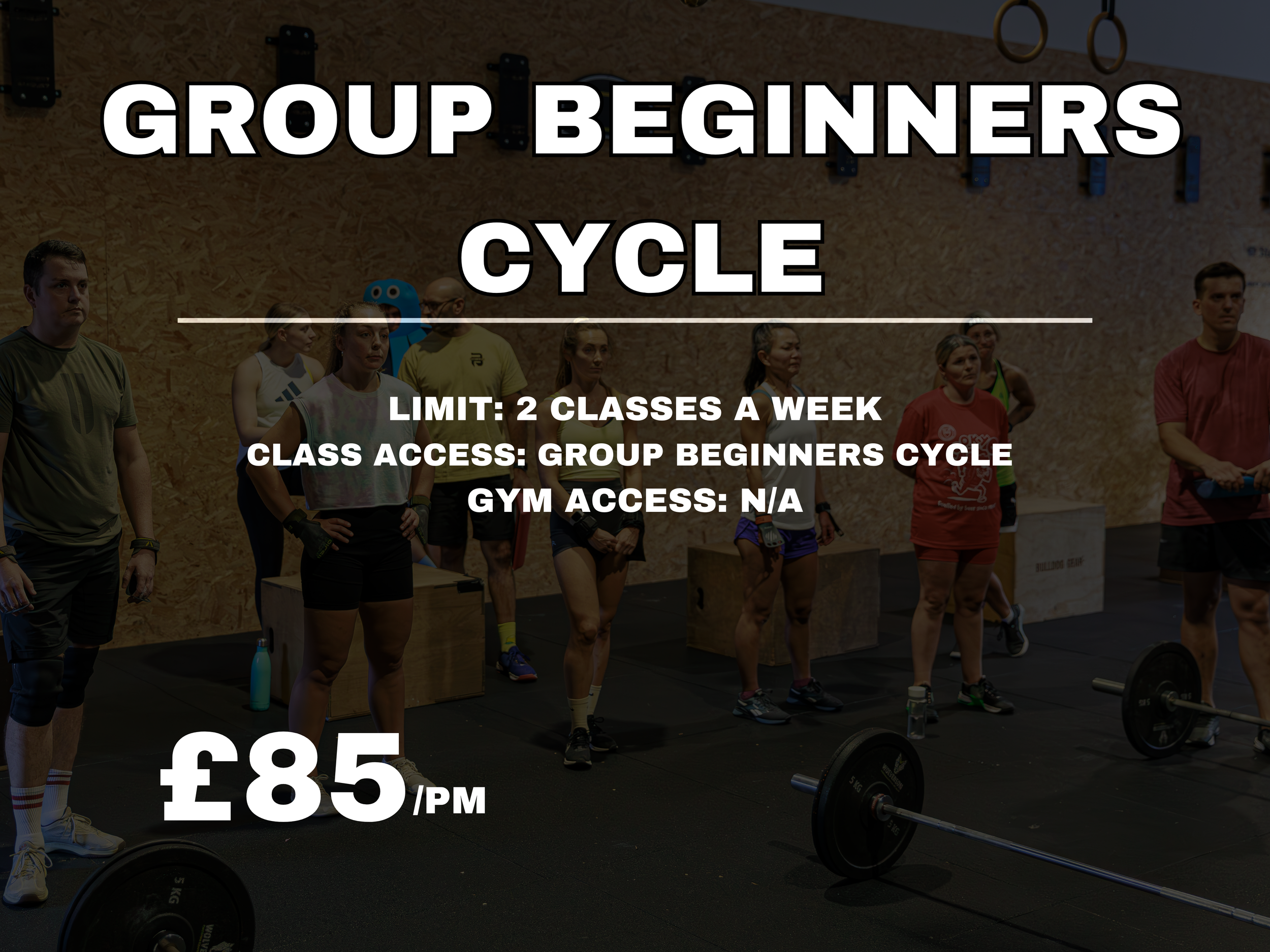 Fitness class with people standing in a gym, preparing for a workout, with weights and gym equipment around.