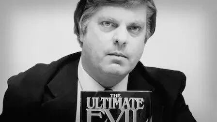 Maury Terry holding his book.