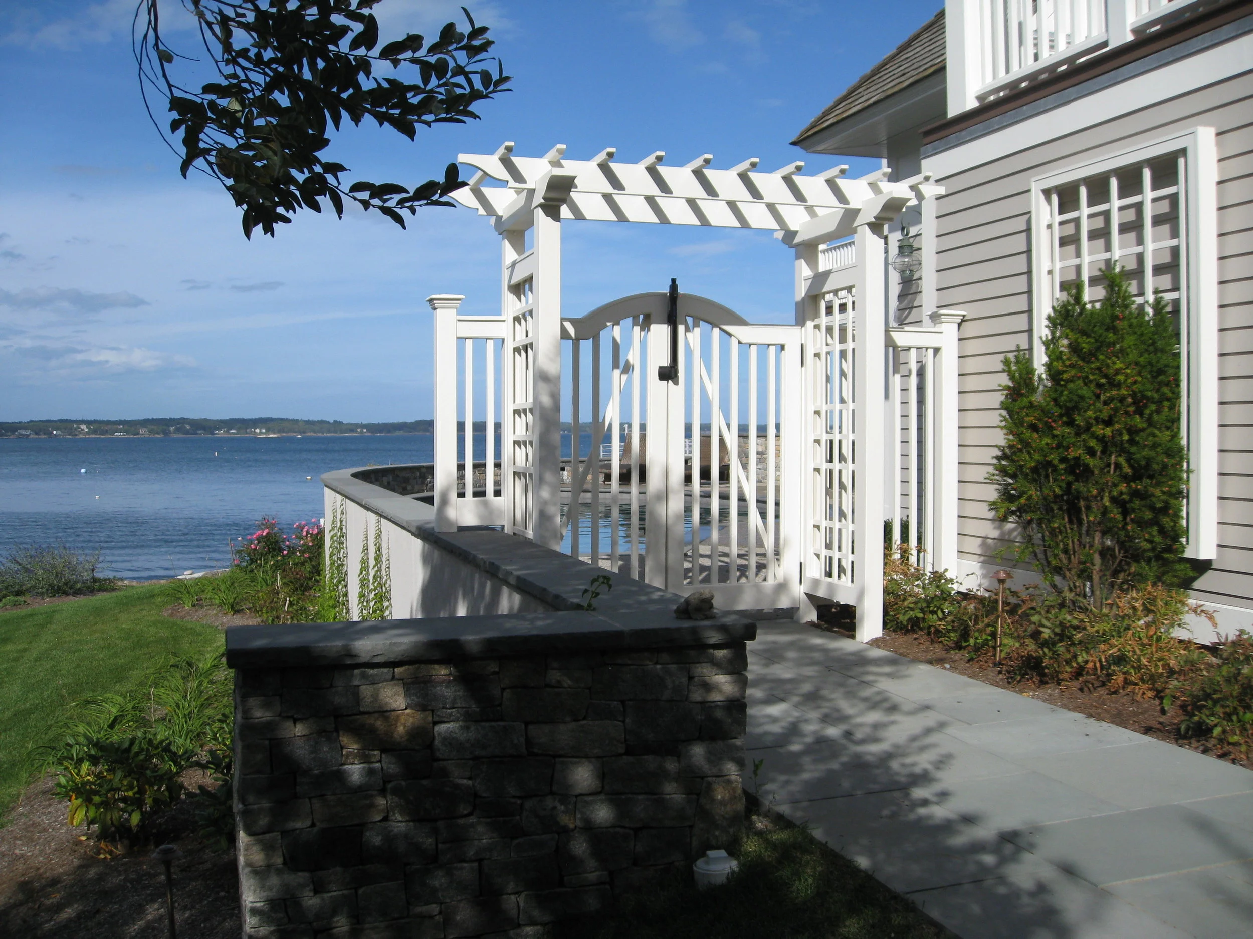 An expansion to a waterfront home adds a swimming pool
