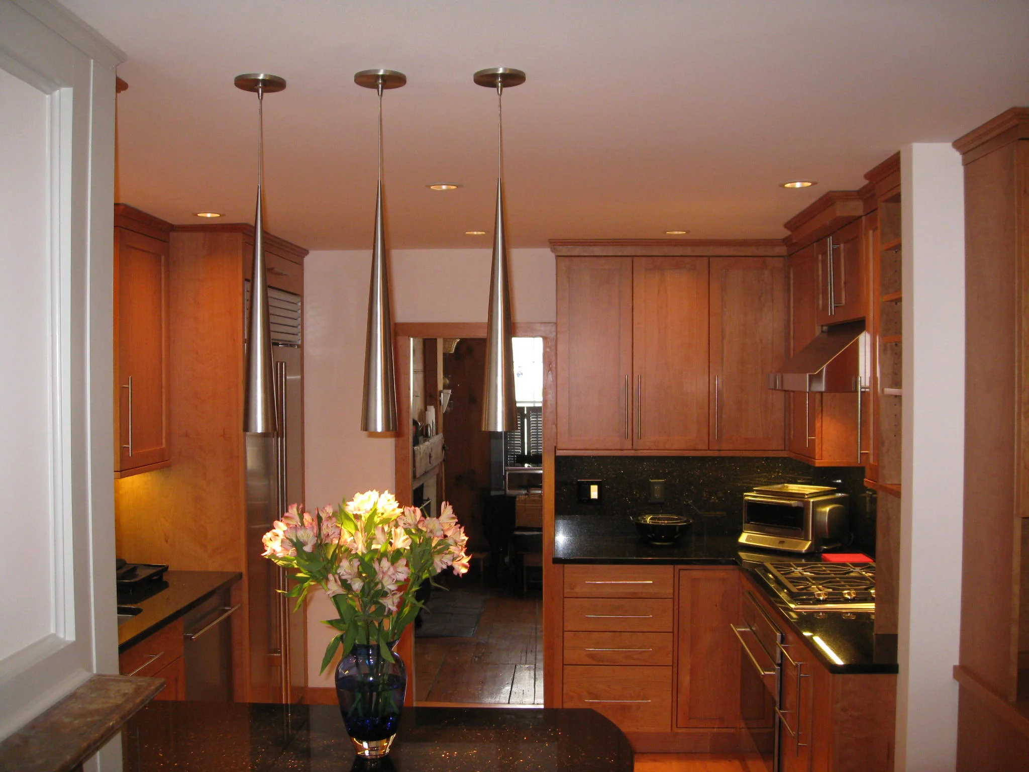 Pendant lighting and a peninsula help to define the spaces