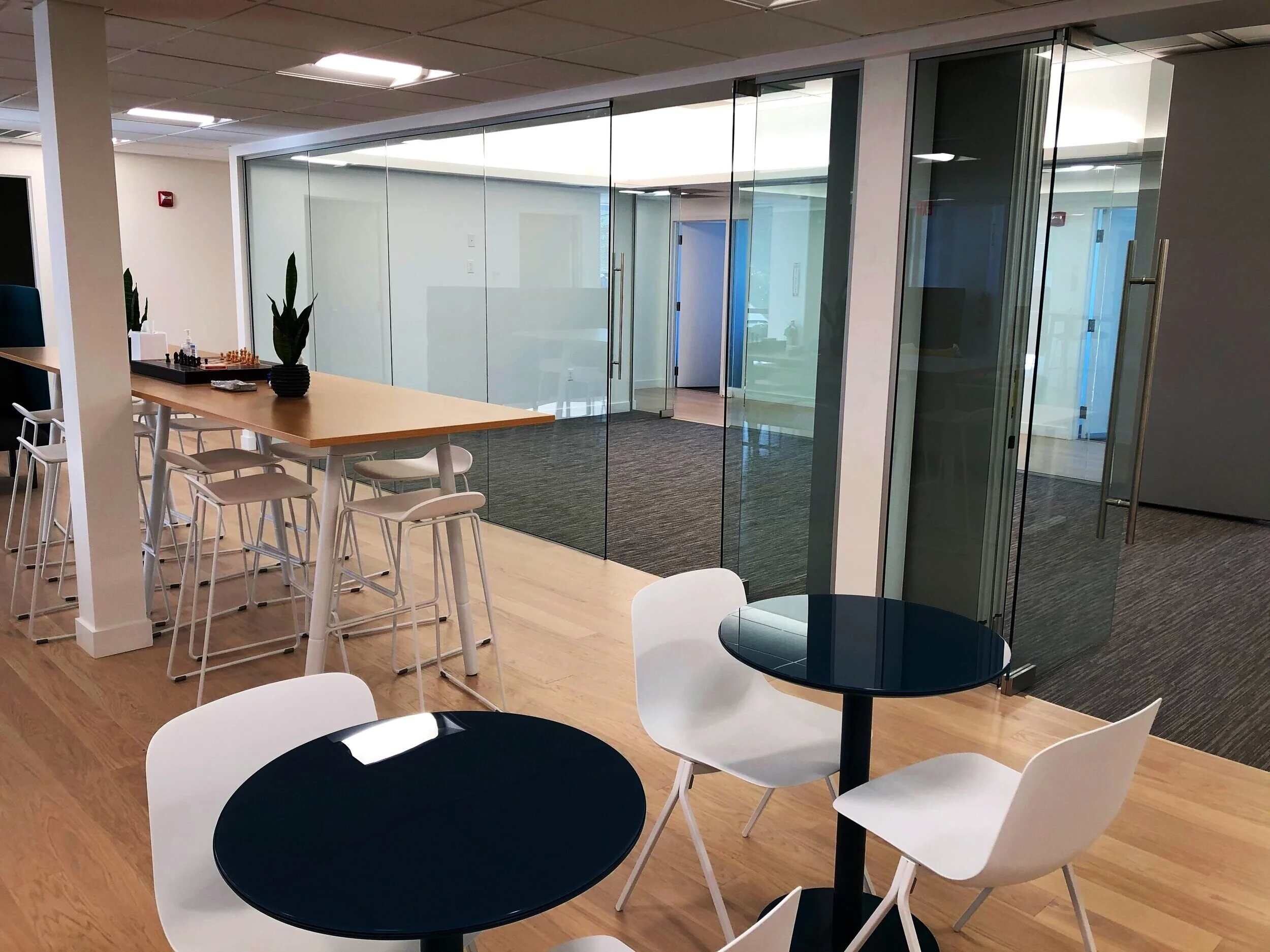  A central conference room has a sheer glass wall to allow views while maintaining sound privacy. 