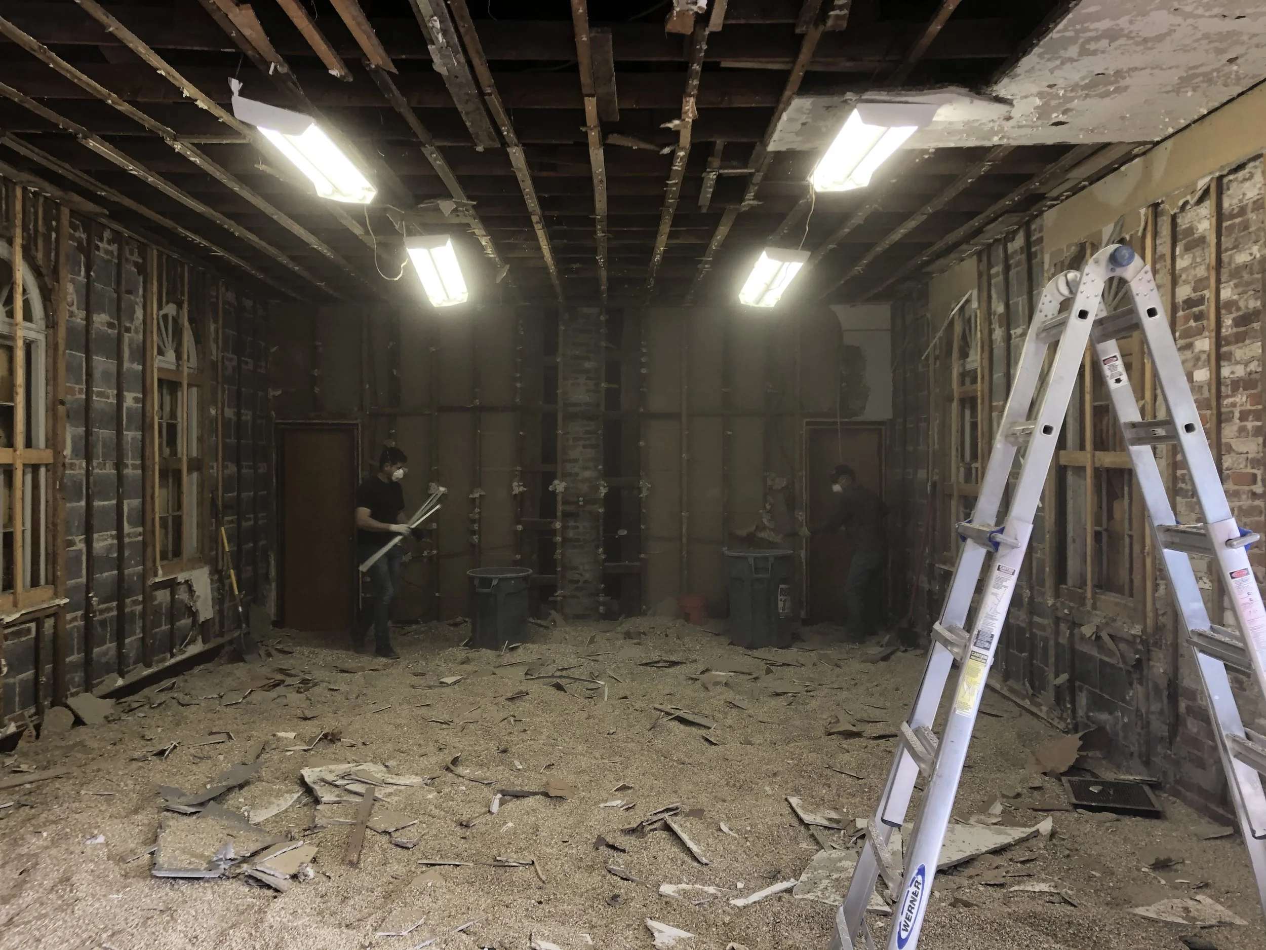The interior of the chapel was extremely dark due to the windows being boarded up,  but the start of renovations exposed potential in the roof framing.