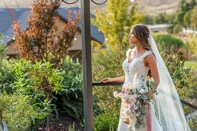 Outdoor wedding ceremony at The Springs, Weddings and Events in Toquerville, Utah with mountain views and waterfall backdrop. Washington Utah Wedding Invitations