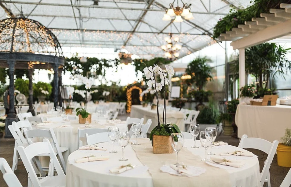 Garden wedding ceremony at Le Jardin Weddings & The Chateau in Sandy, Utah with fountains and landscaped greenery. Indoor greenhouse wedding reception at Le Jardin Weddings in Sandy, Utah featuring lush foliage - le jardin wedding invitations