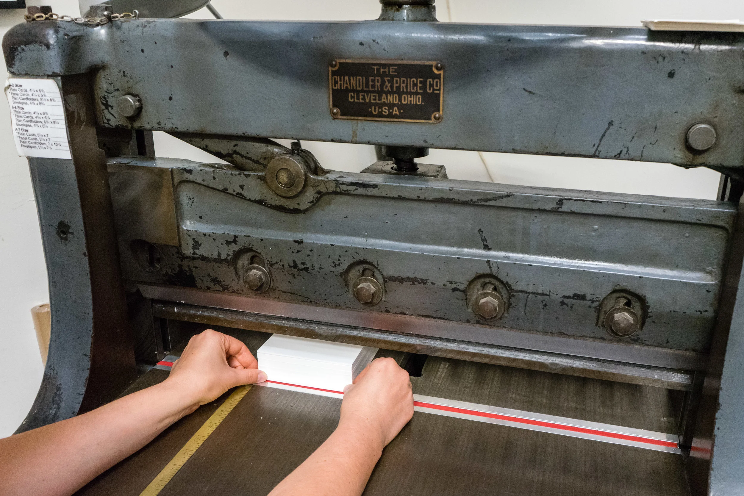 Cutting cotton paper down to size for invitation printing