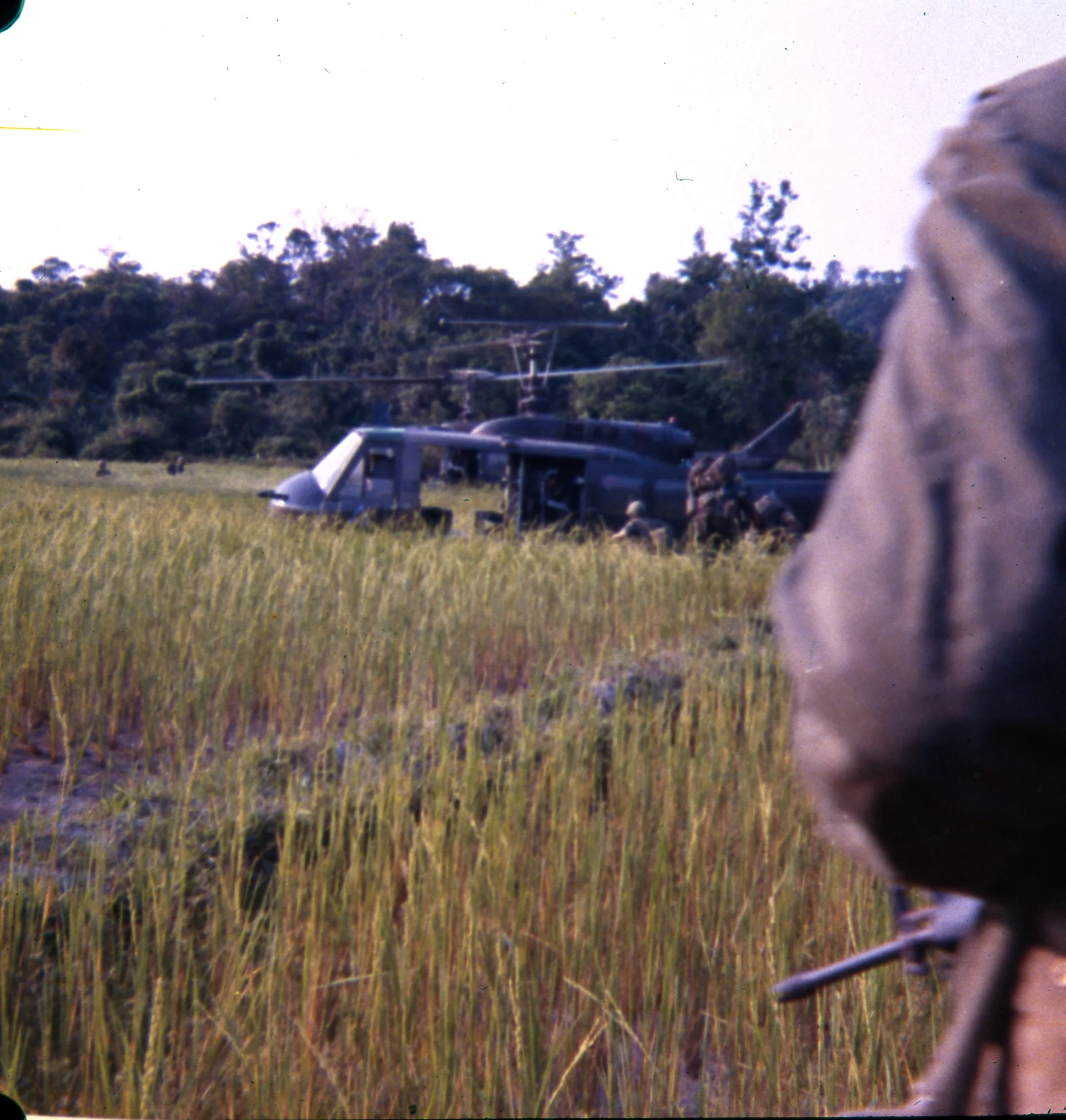 Alpha Company soldiers make their way toward choppers waiting in a rice paddy landing zone.