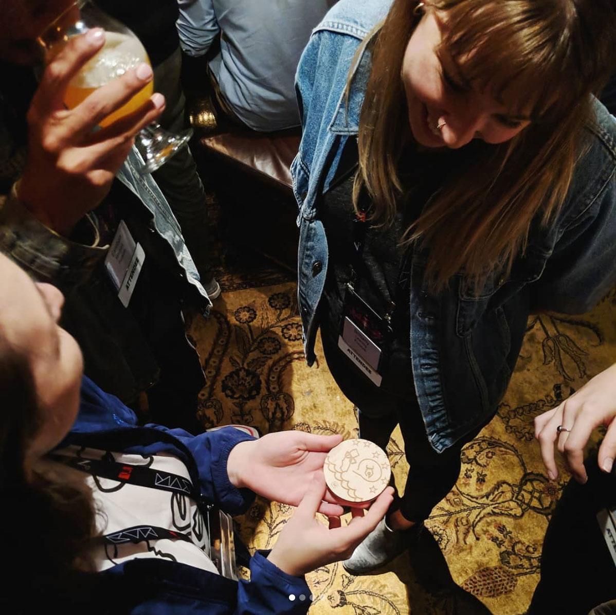 Guests gathered around a custom designed coaster
