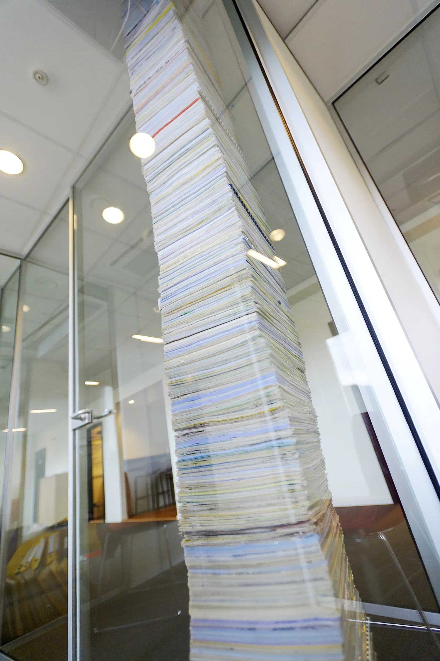 Deloitte's own documents (1999 - 2009) stacked from floor to ceiling, epoxy