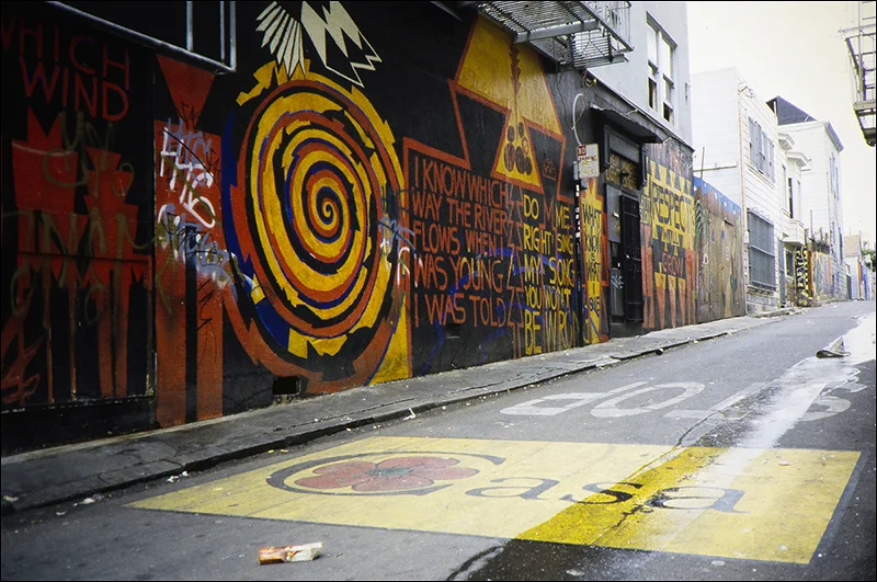 Home/Casa (ground) by Megan Wilson, 2000; and I Know Which Way the River Flows (wall) by Brian and Jasper Tripp, 1998; Clarion Alley, Mission District, San Francisco