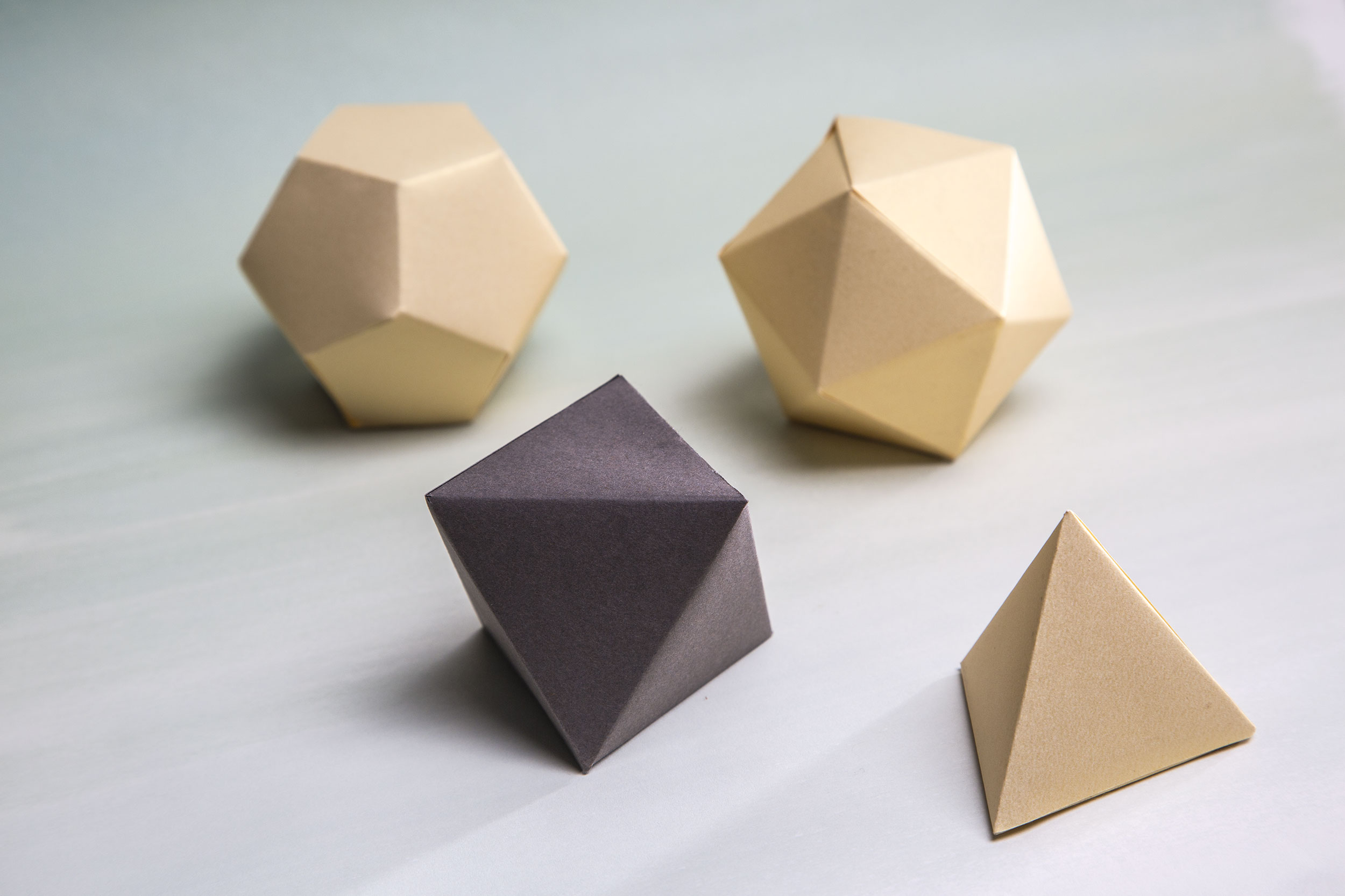 Geometric shapes made out of paper that serves as packaging for the pieces.