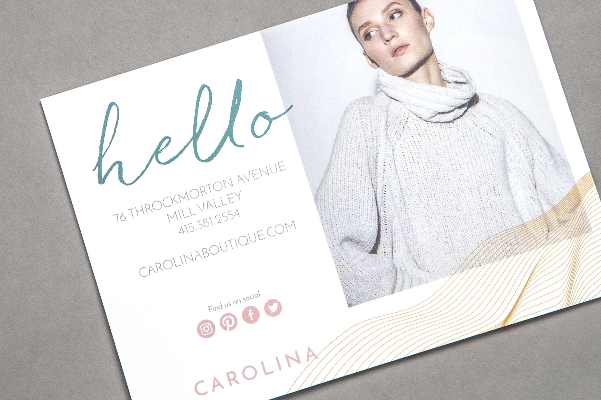 In-store postcard collateral with woman wearing sweater.