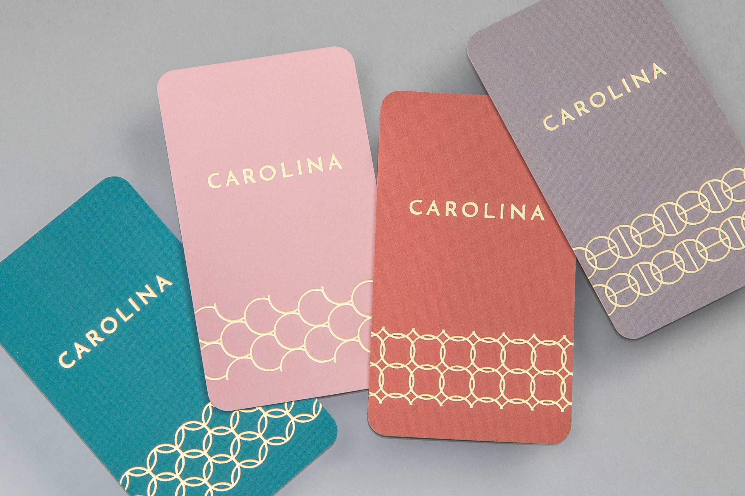 Business cards with unique pattern designs in gold designed for the creative brand Carolina Boutique.