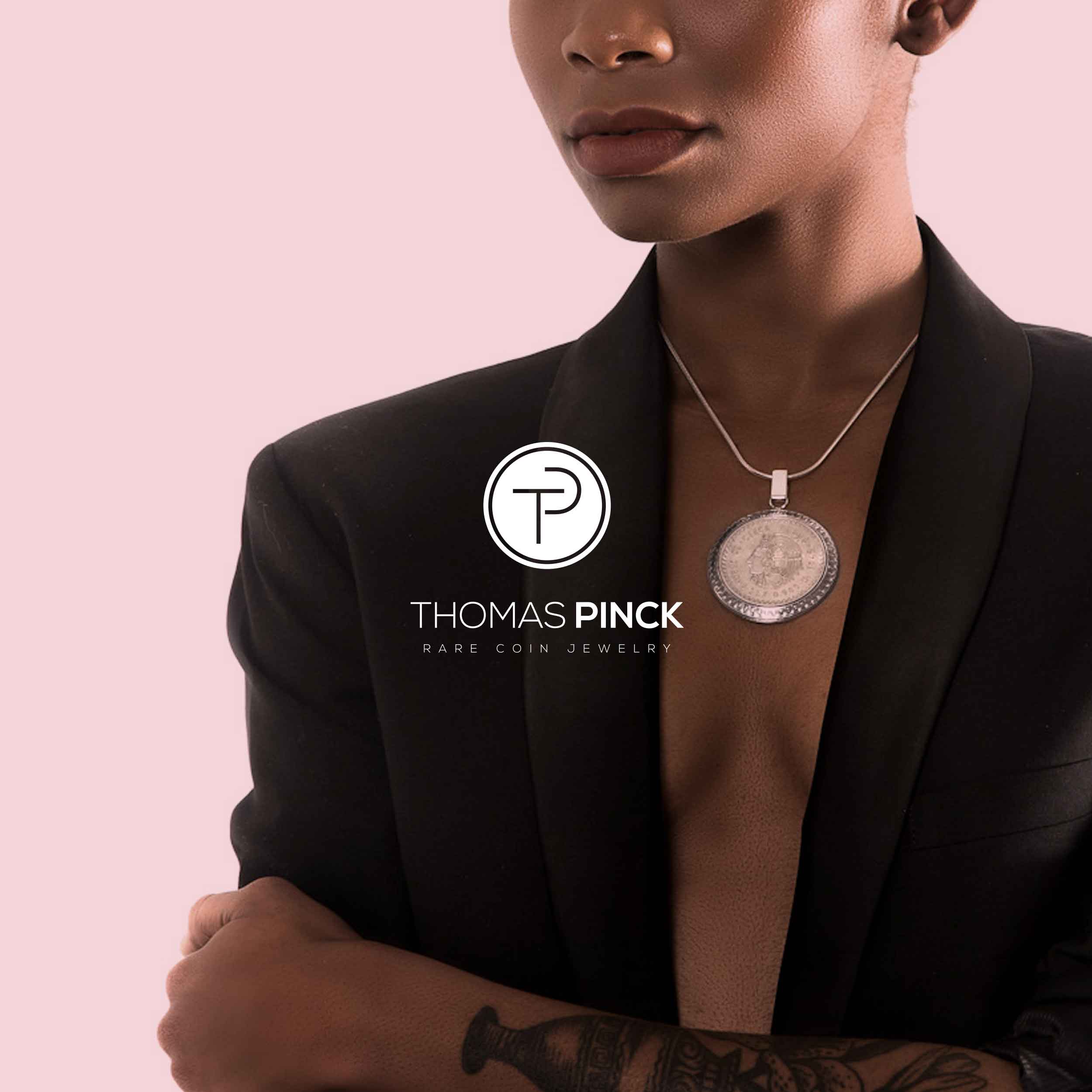 An African American model wearing a Thomas Pinck rare coin jewelry necklace. (Copy)