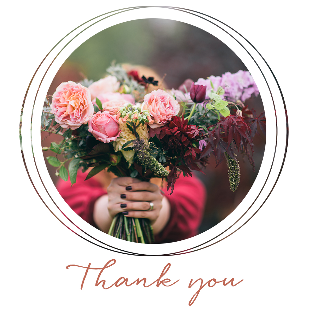 A female holding a bouquet of flowers for a Thanksgiving social media post for Carolina Boutique clothing brand.