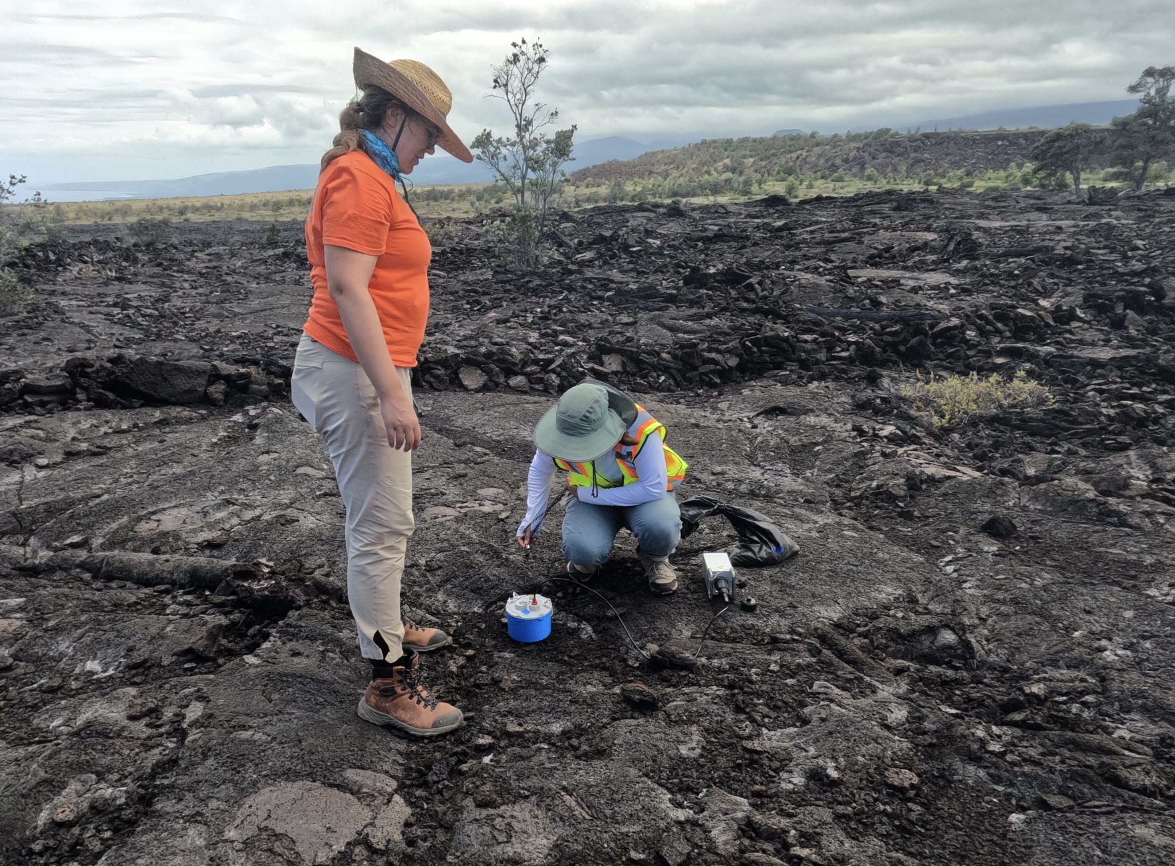  MS student Jade Wight turning on a nodal seismometer with collaborator Dr. Ninfa Bennington during the 2022 Pāhala deployment. 