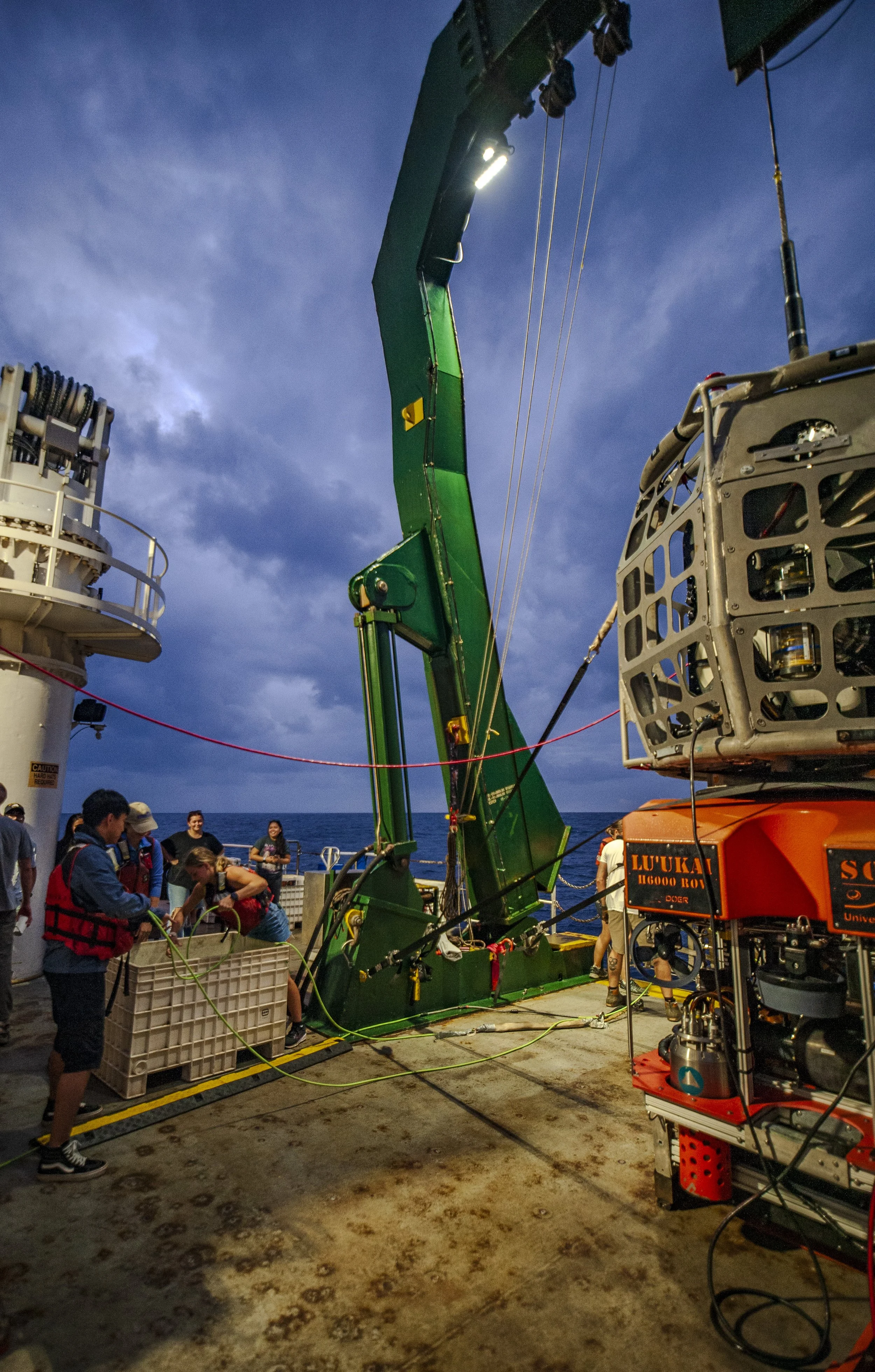 Undergraduate student Casey Wandasan aboard the R/V Kilo Moana helping to bring in the Magnetometer. 