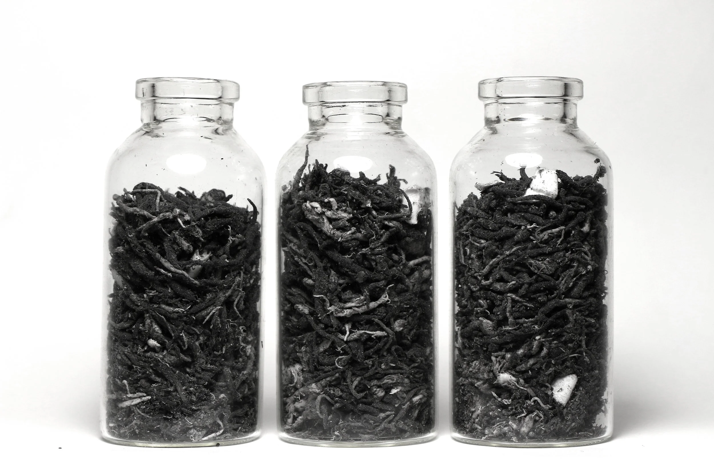 Before It Was Bad, It Was Better (Remnants) Graphite, eraser, paper, three glass jars, Each 1" x 1" x 3", 2018.