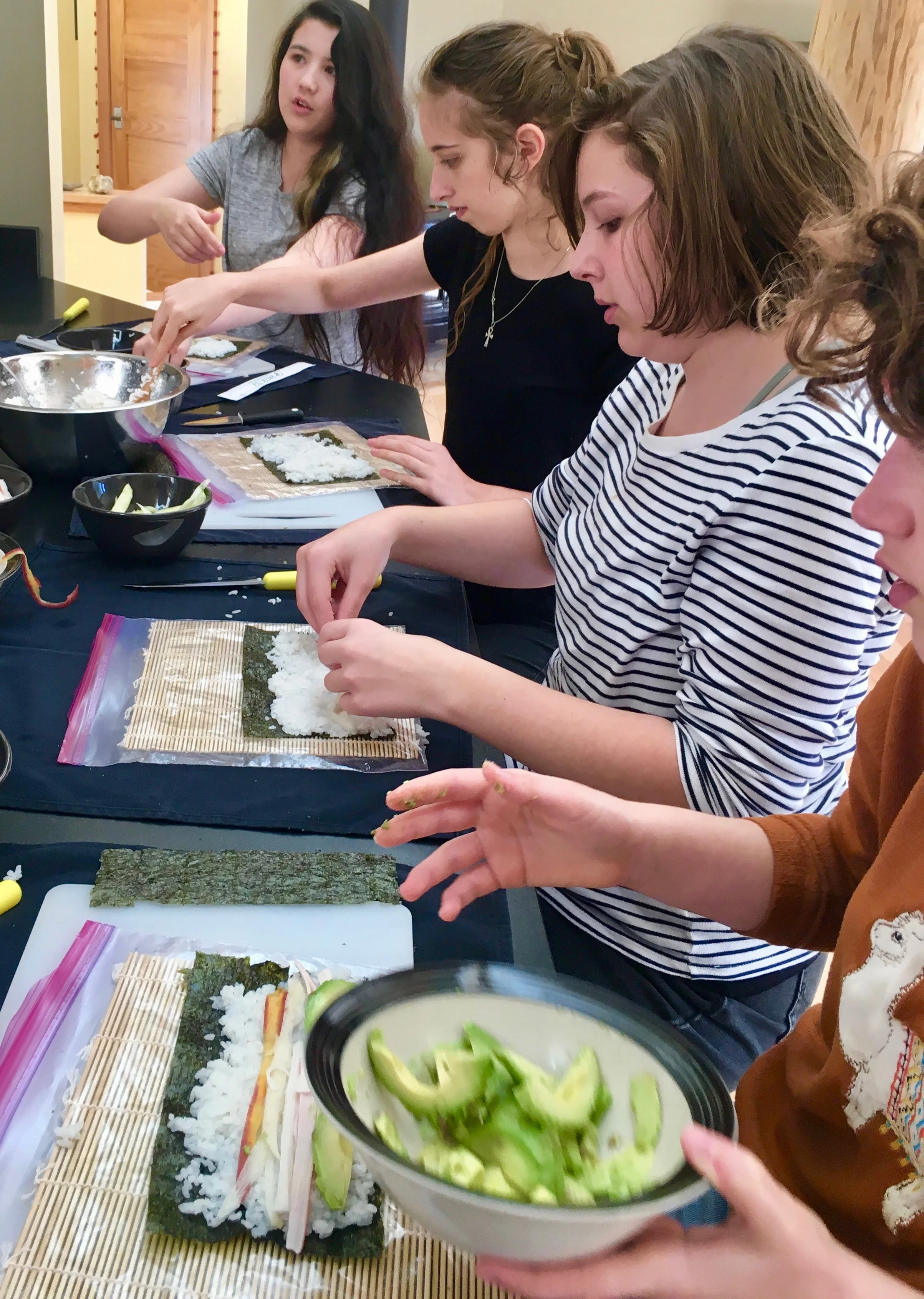 Learning to make sushi in cooking class