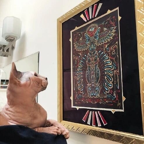 It's International Cat Day, and if you know anything about us here at the shop, we all absolutely adore cats! Here's a throwback to this awesome, iridescent Egyptian cat print by @zendragongallery that we framed last year, and the approving customer?