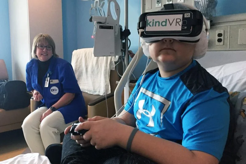 Leukemia patient Tommy Peachock, 12, got lost in an underwater world, thanks to help from volunteer Jessica Benson and the hospital’s new virtual reality (VR) technology.