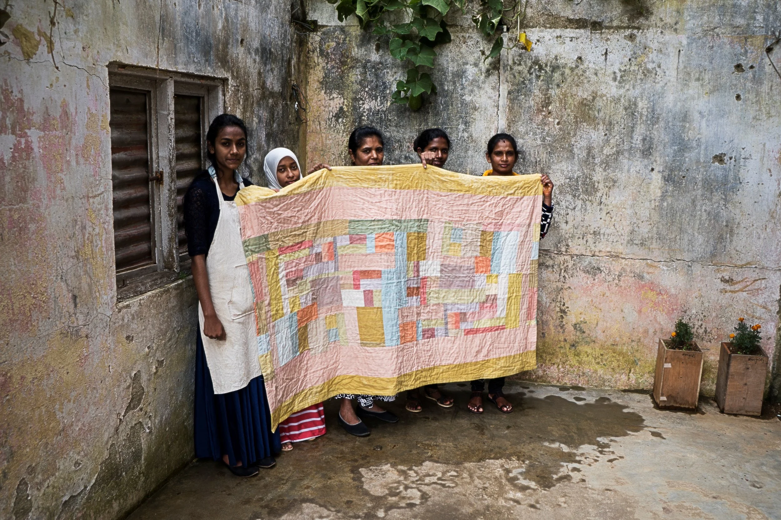 The AMMA crew showing one of their signature pieces – a patched blanket. Photo: Maria Lundin Osvalds