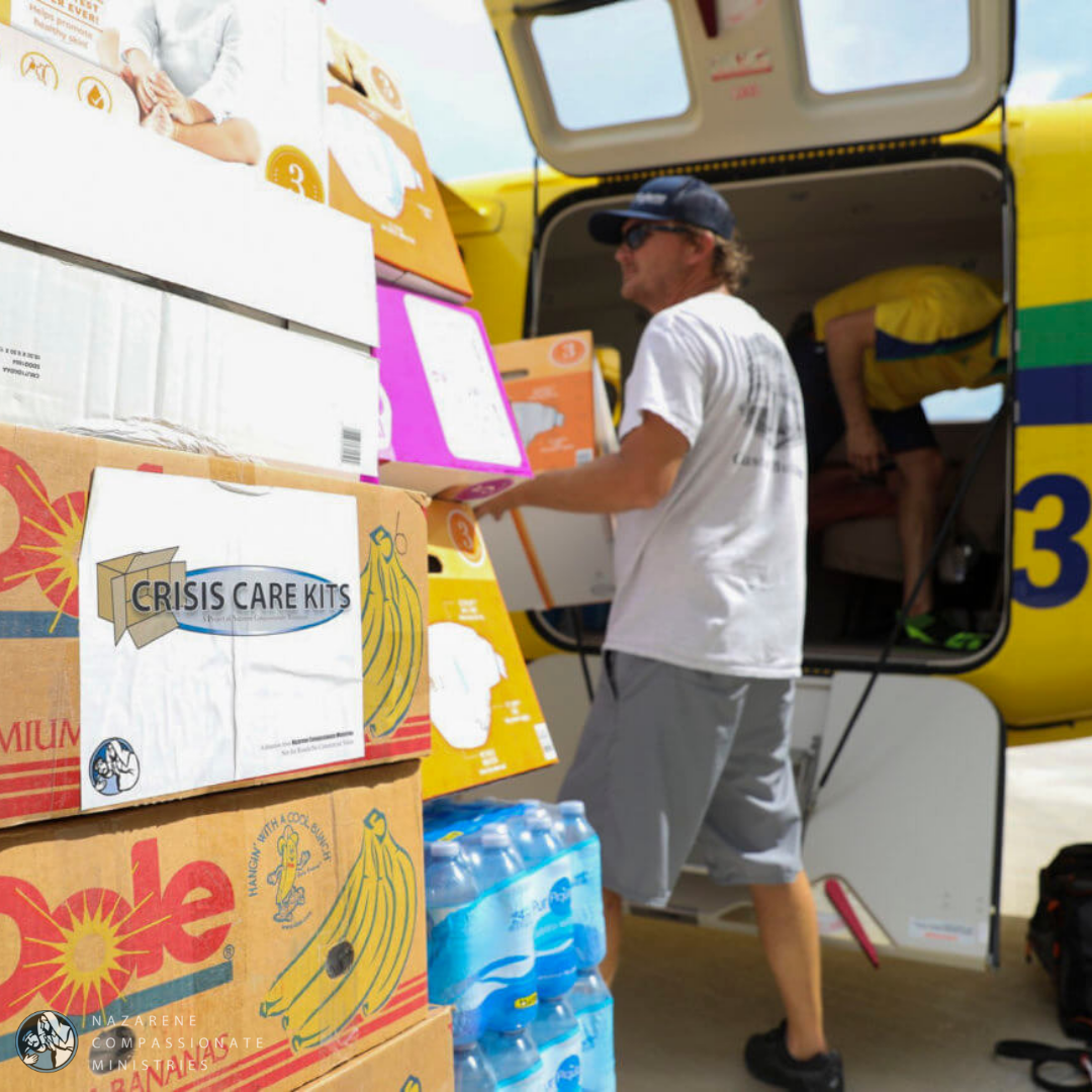 Volunteers unload crisis care kits from a plane in Nassau, Bahamas. (Photo/Jess Heugel)