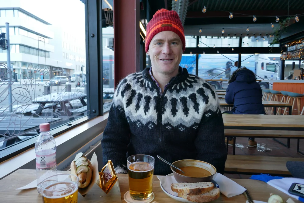  Julien in his new sweater sampling fish soup and an Icelandic hot dog 