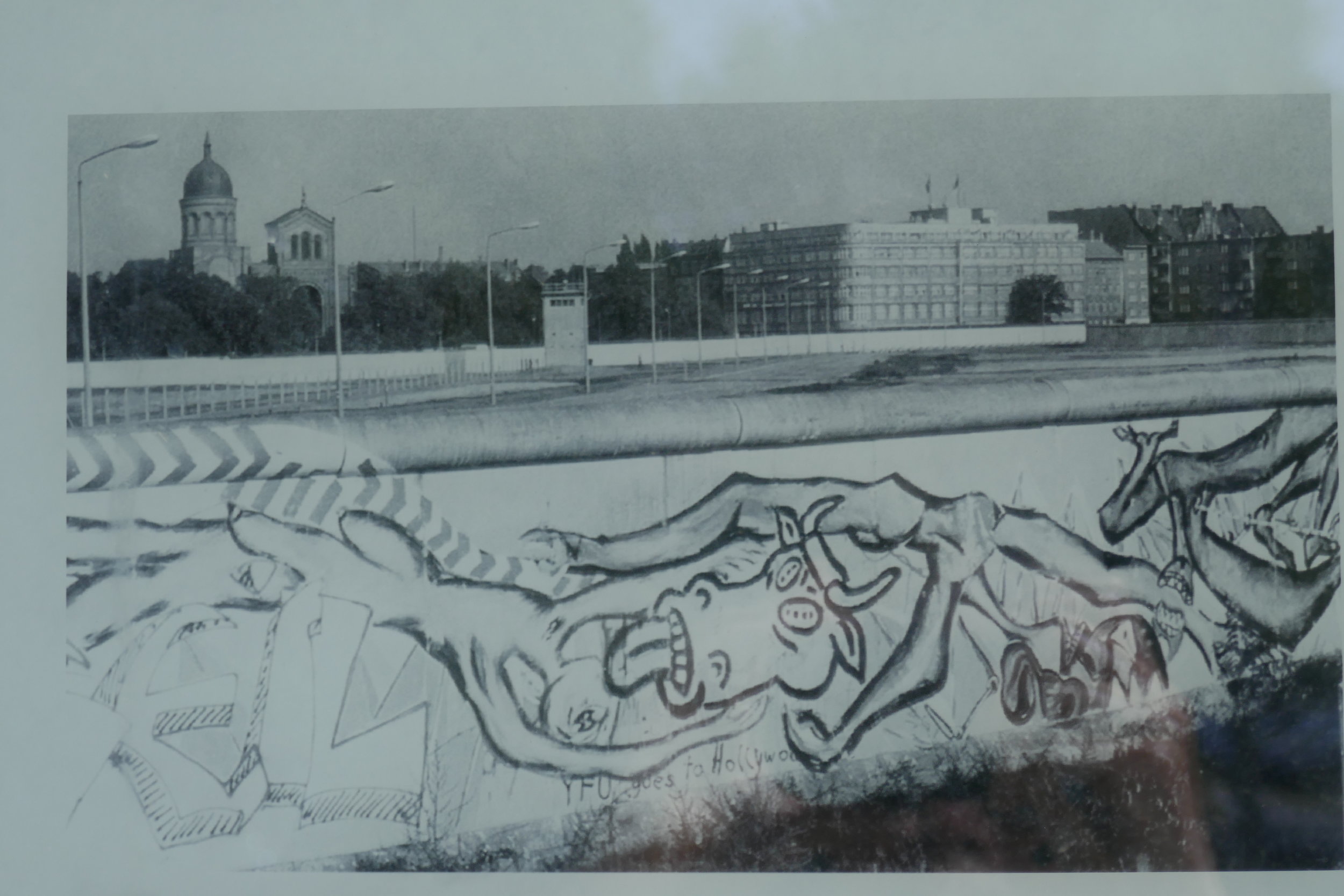  Graffiti on the west side of the wall; behind the death strip, you can see the St. Michael Kirche in the background 