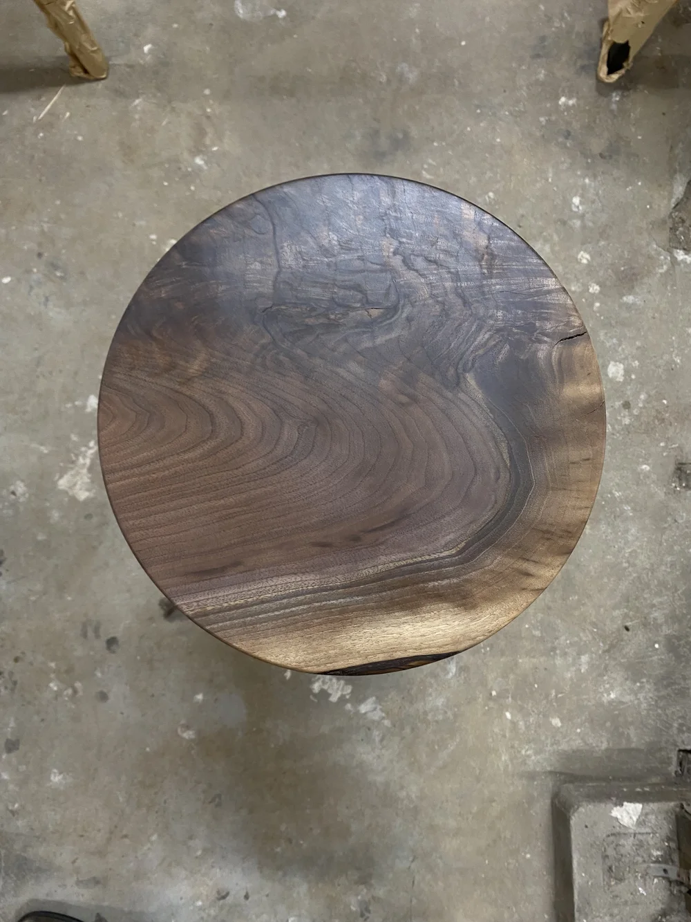 custom made high top stools with black walnut wooden seats and black metal base.