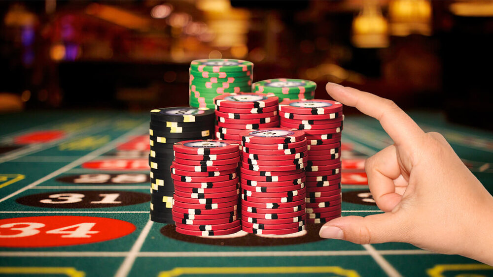 A-Hand-Placing-a-Stack-of-Casino-Chips-on-a-Roulette-Table.jpg