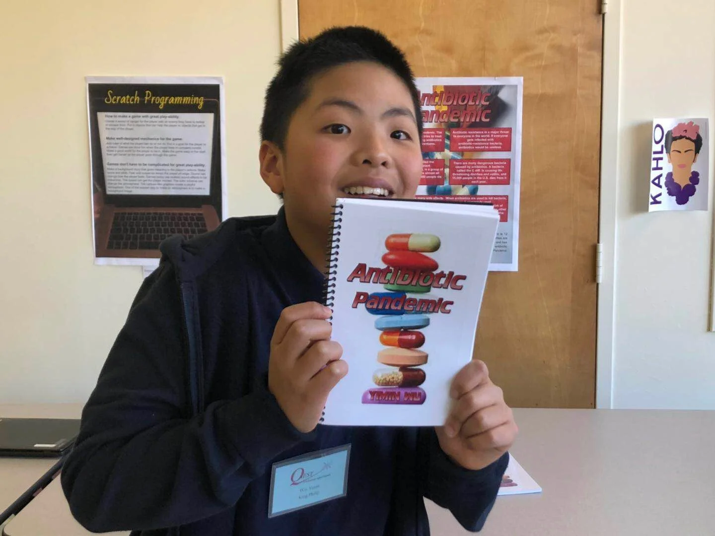 Yimin with his book.jpeg