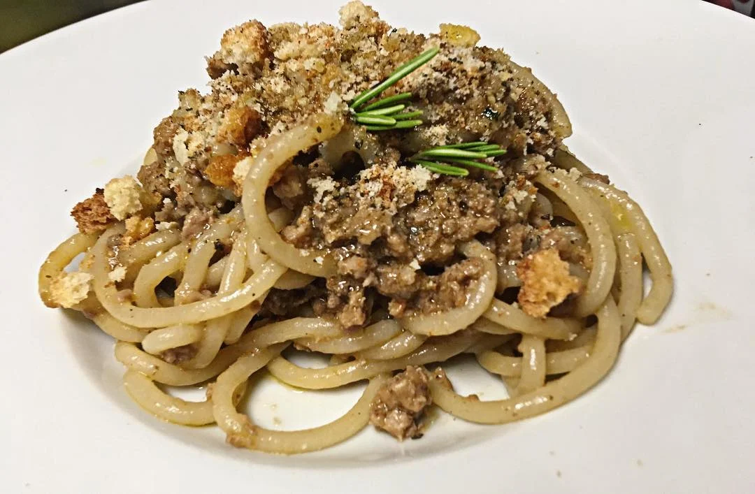 Pici al ragú di cinta con briciole di pane croccante ale erbe aromatiche
