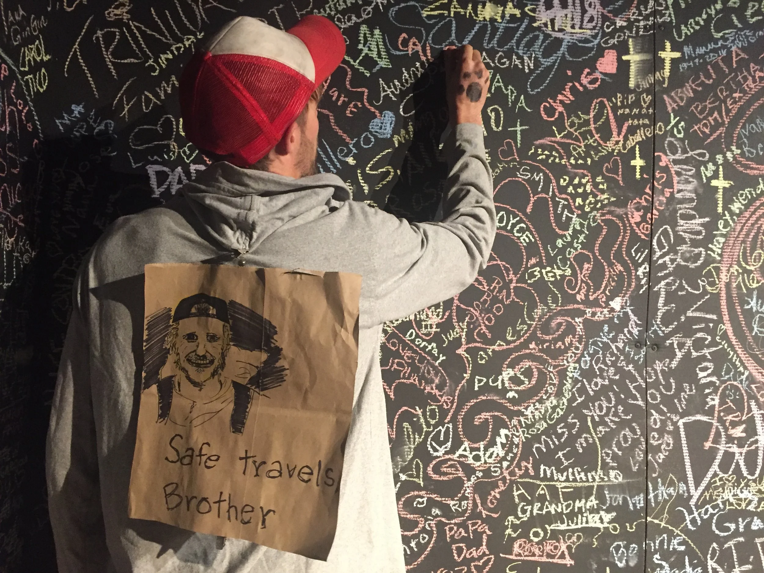  Remy adds Caleb's name to the mural at the  All Souls Procession &nbsp;in Tuscon, AZ. The event gathers thousands to parade and celebrate lost loved ones each year. Remy and Anna Morenz carried the poster and a candle in Caleb's memory. 